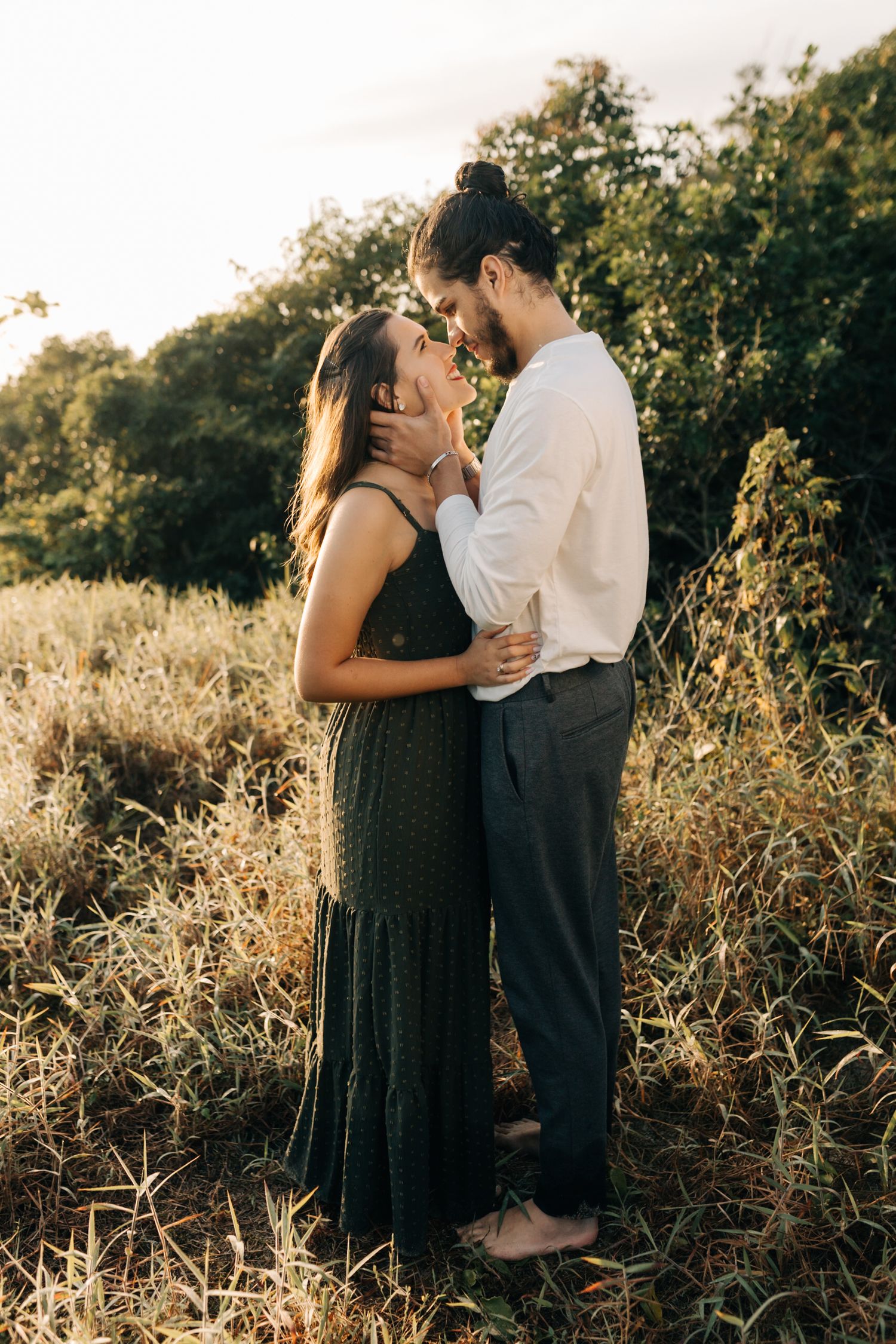Romantic sunset engagement photos in tall golden grass.