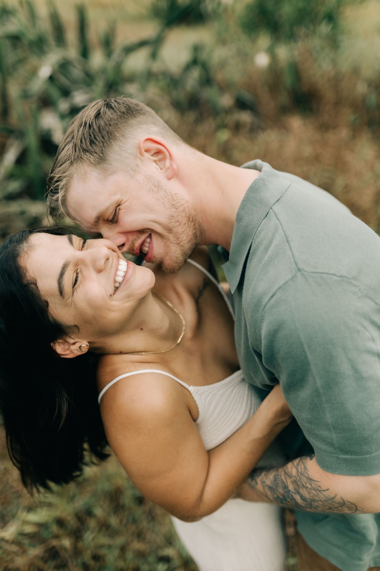 A sequence of joyful expressions between a couple during an outdoor portrait session.