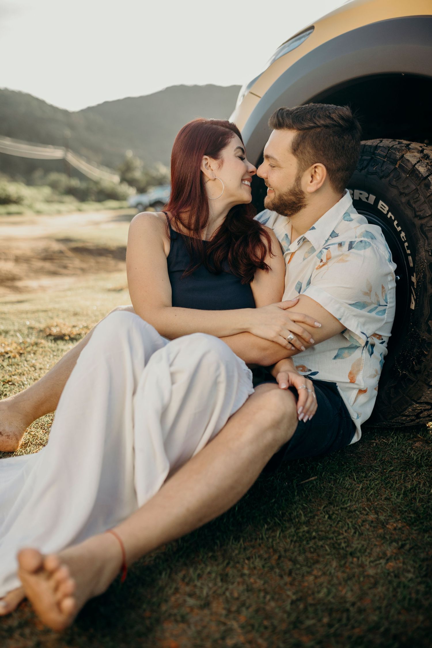 Intimate moment shared beside yellow pickup truck during sunset photo session.