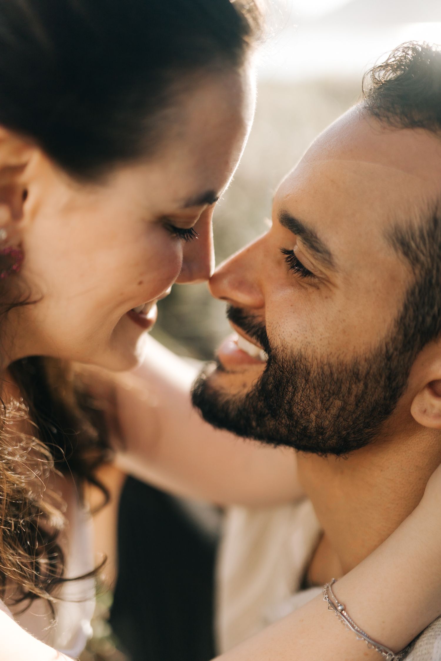 Close-up romantic portrait captures intimate tender moments between couple.