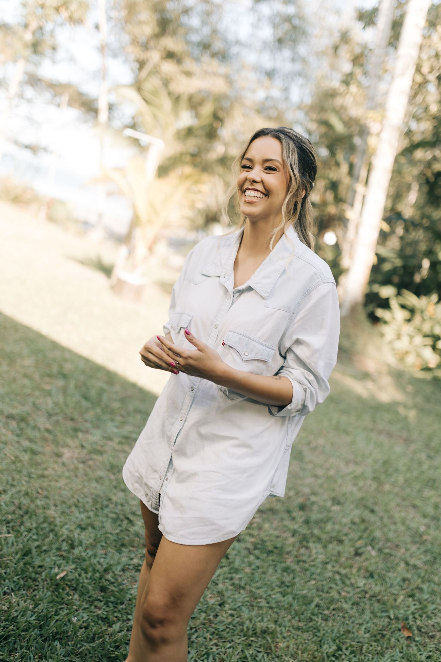 Candid shots of someone laughing joyfully in a white shirt against a natural outdoor setting.