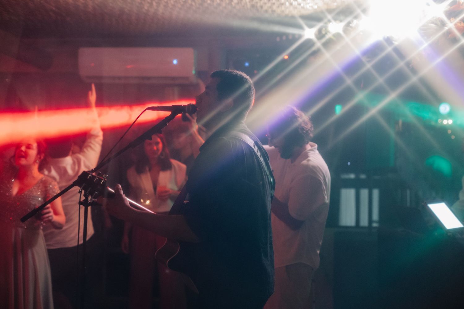 Concert venue with dramatic lighting and smoke effects creating a moody atmosphere.