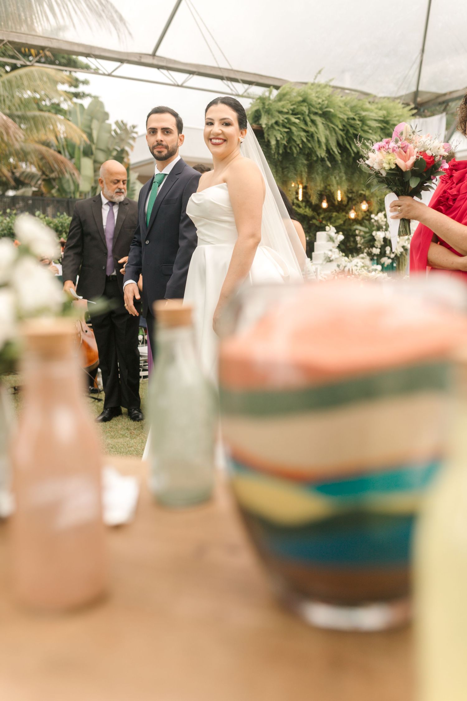 Wedding reception table setup with decorative sand art vessels and refreshments.