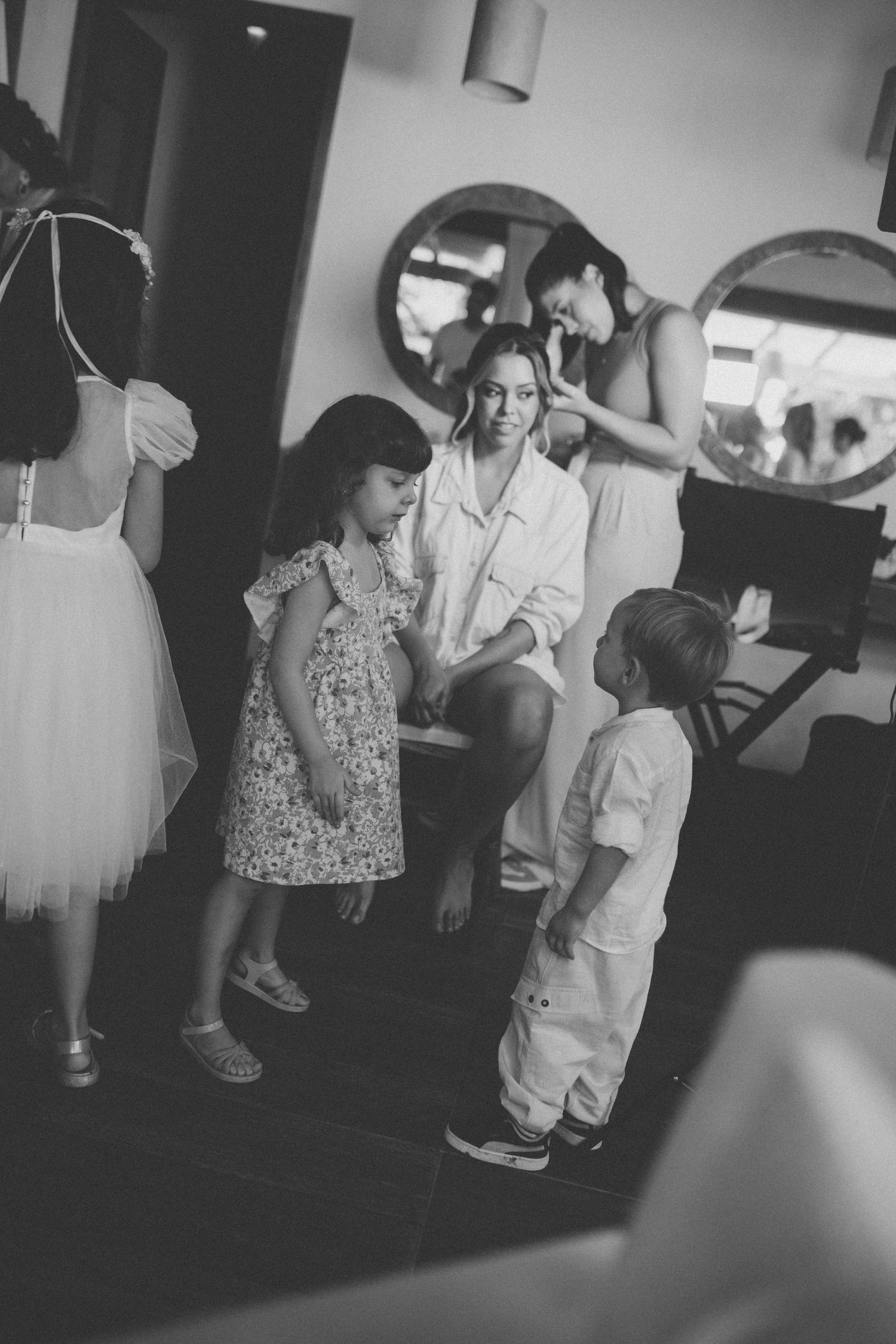 A black and white photo shows people gathering indoors during a special event.