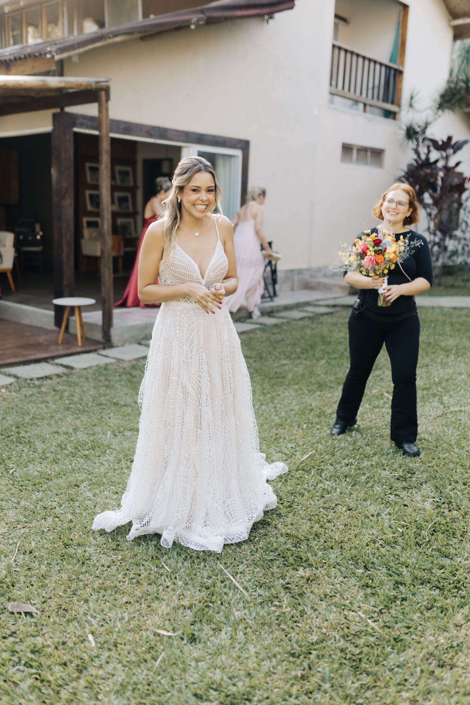 Classic white wedding gown captured during an outdoor photo session on a lawn.