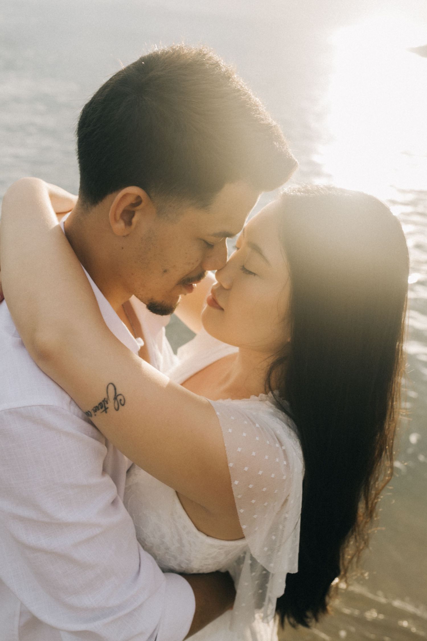 Intimate closeup of couple sharing romantic moment by the ocean.