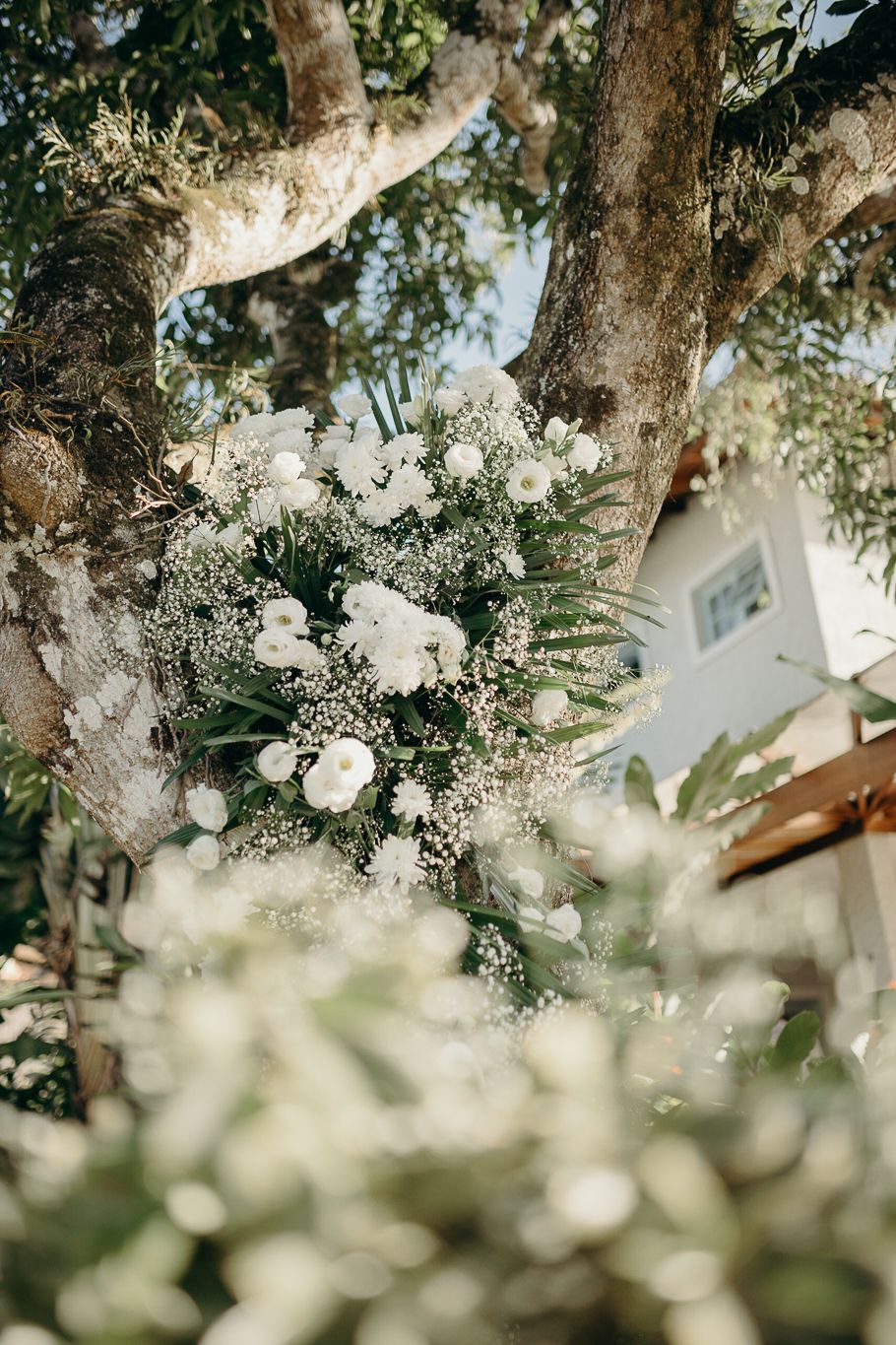 Delicate white flowers and greenery create a soft, romantic ceiling installation.