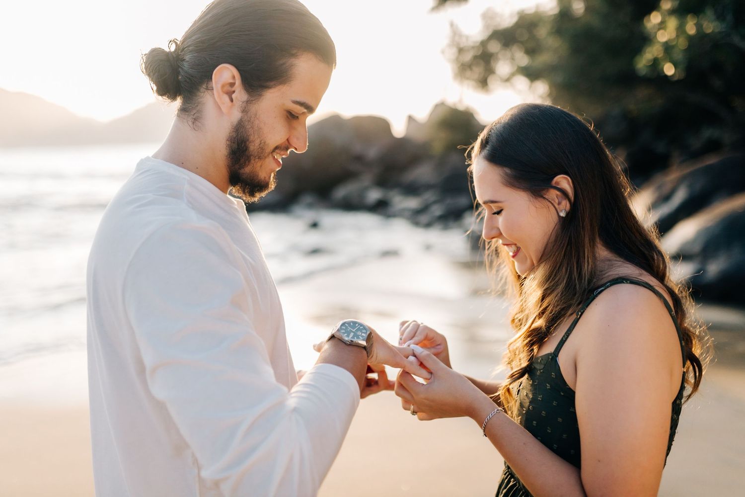Intimate proposal scene captured on a scenic beach during sunset.