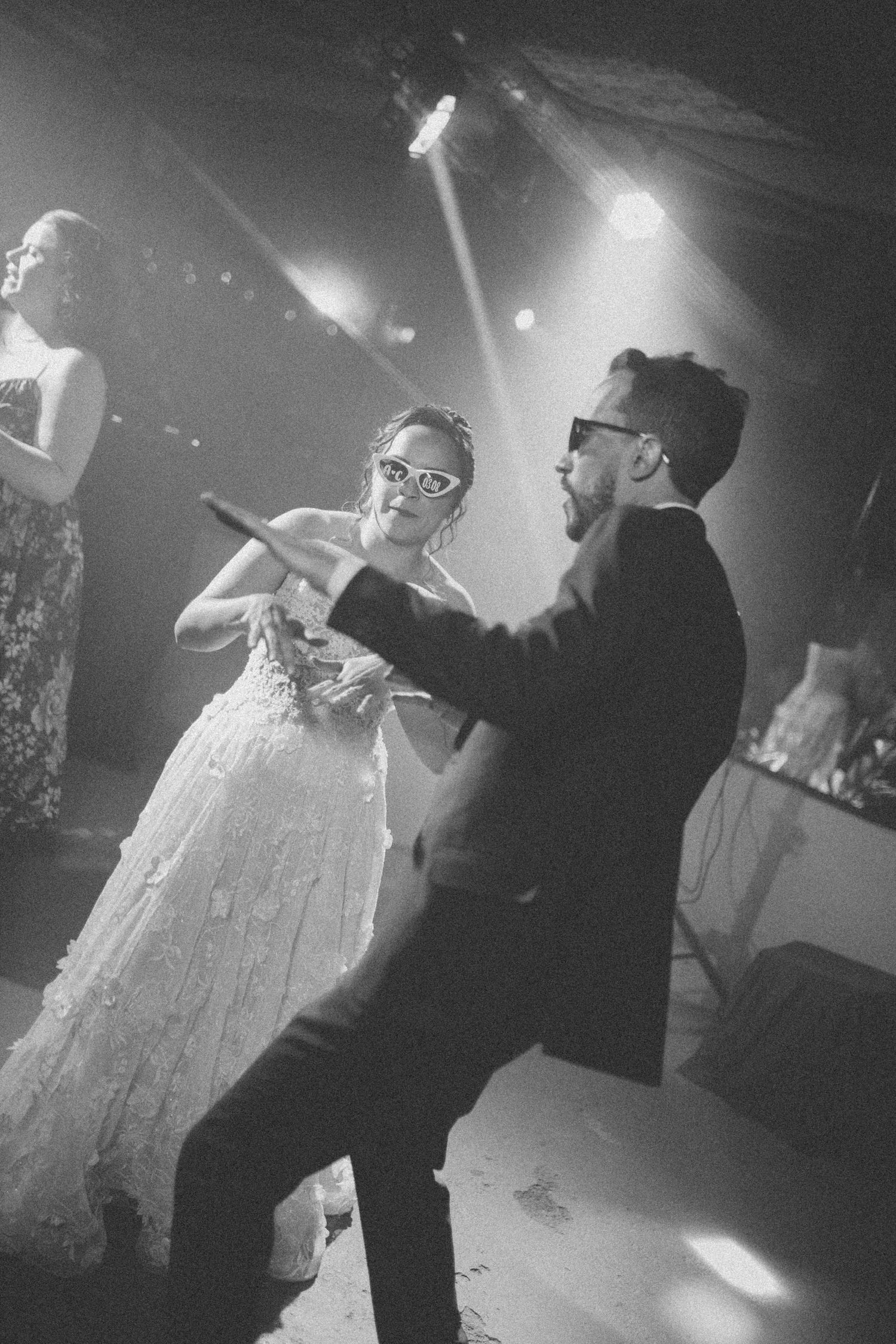 Black and white dance floor moment captured during a wedding celebration.