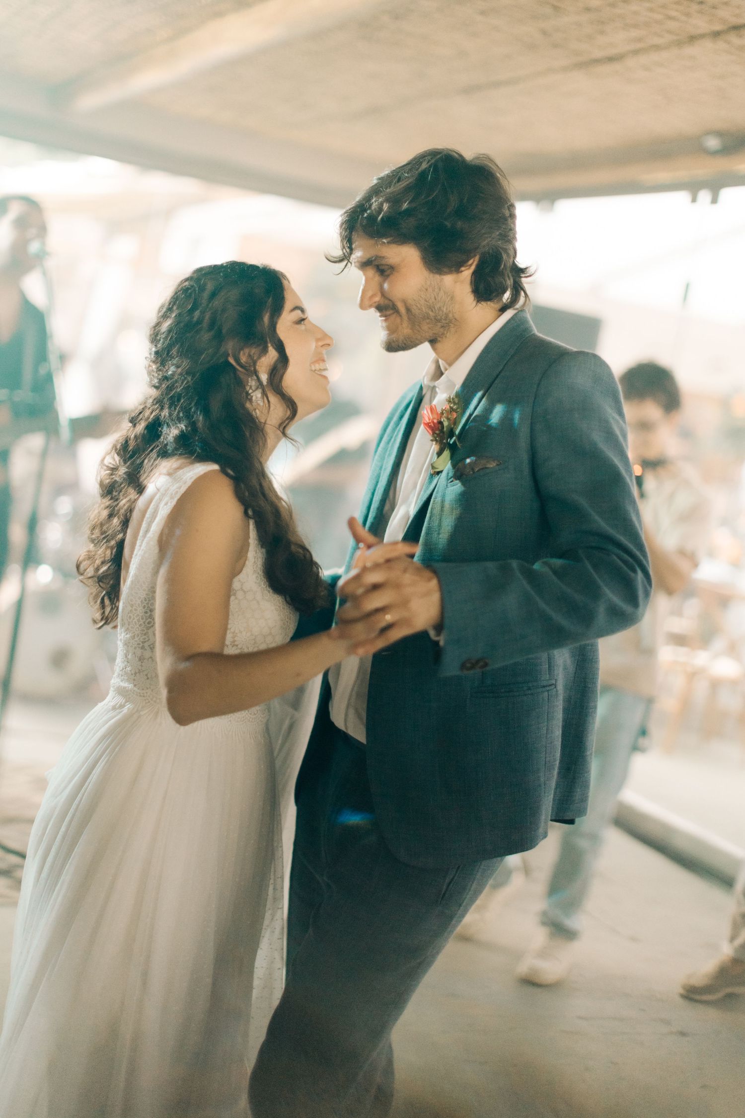 Couple sharing a playful dance moment at a formal event.