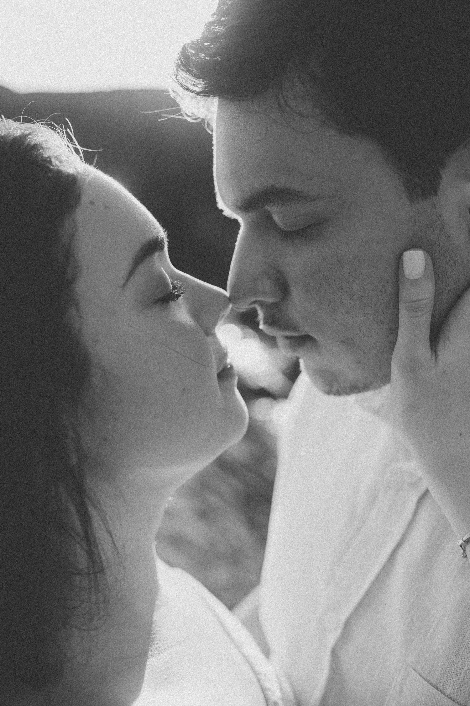 Close-up black and white portraits capturing tender intimate moments between two people.