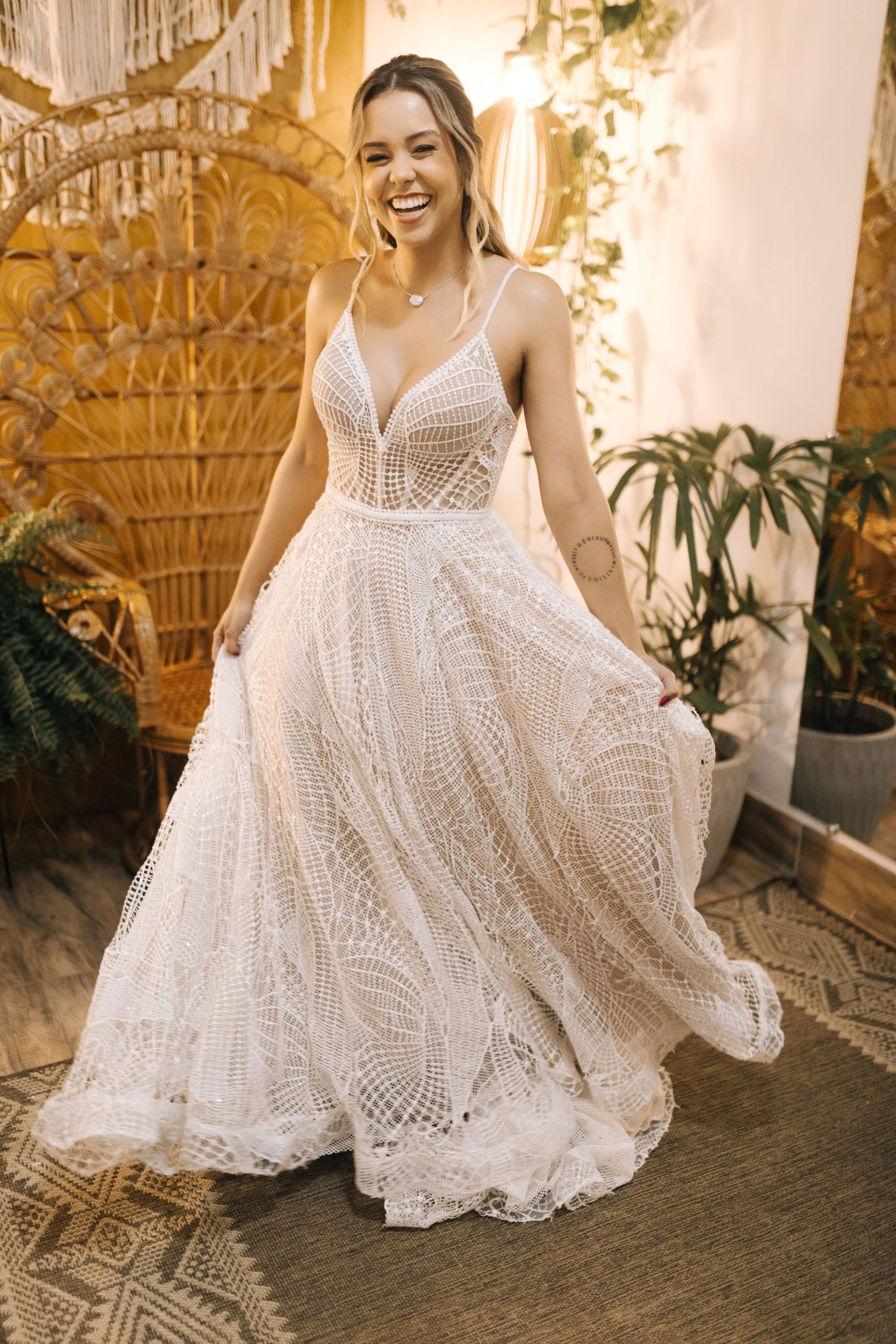 Stunning lace wedding dress with detailed bodice and flowing skirt in boho style.