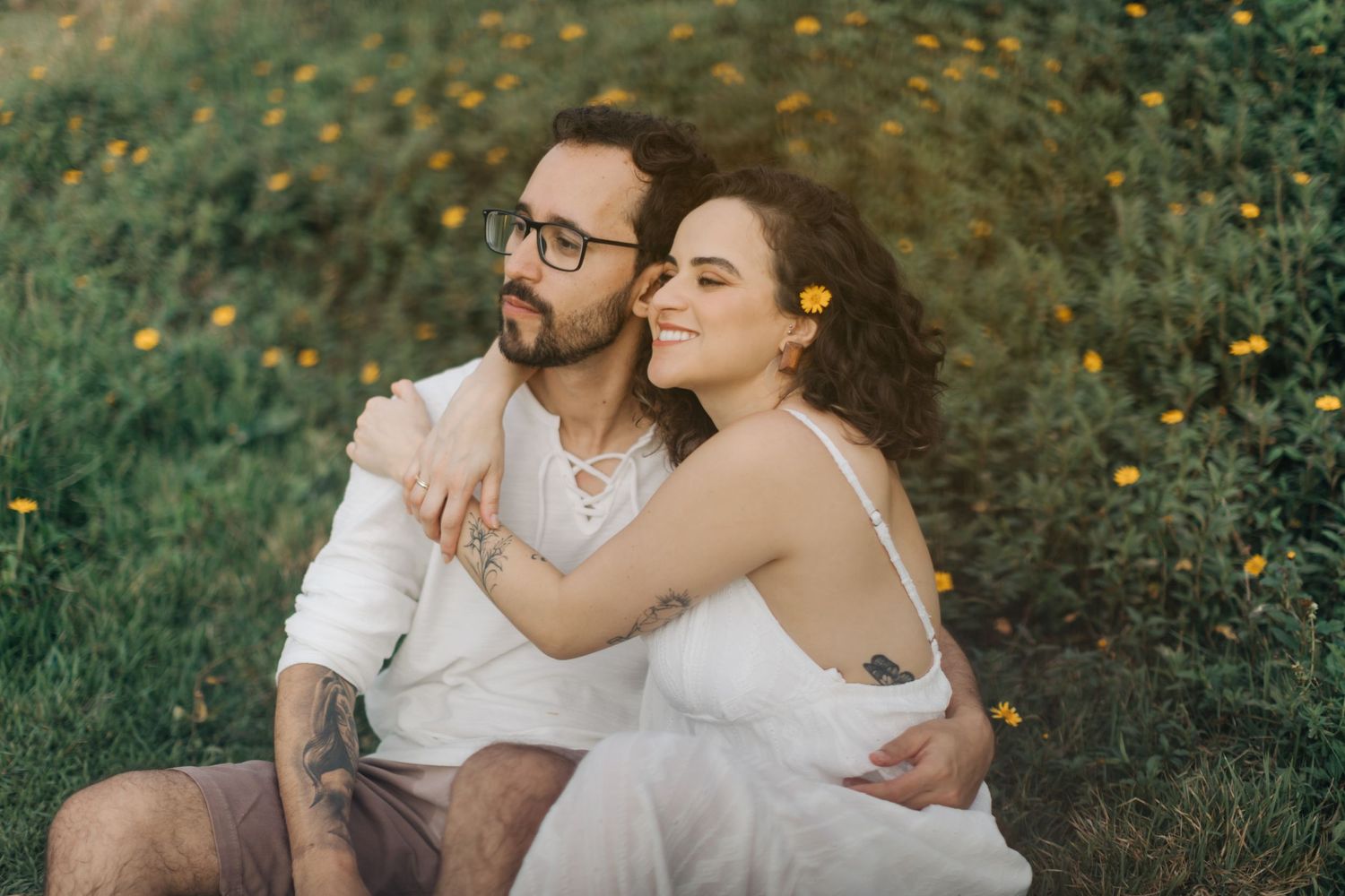 Intimate couple portraits captured in natural outdoor setting with greenery.