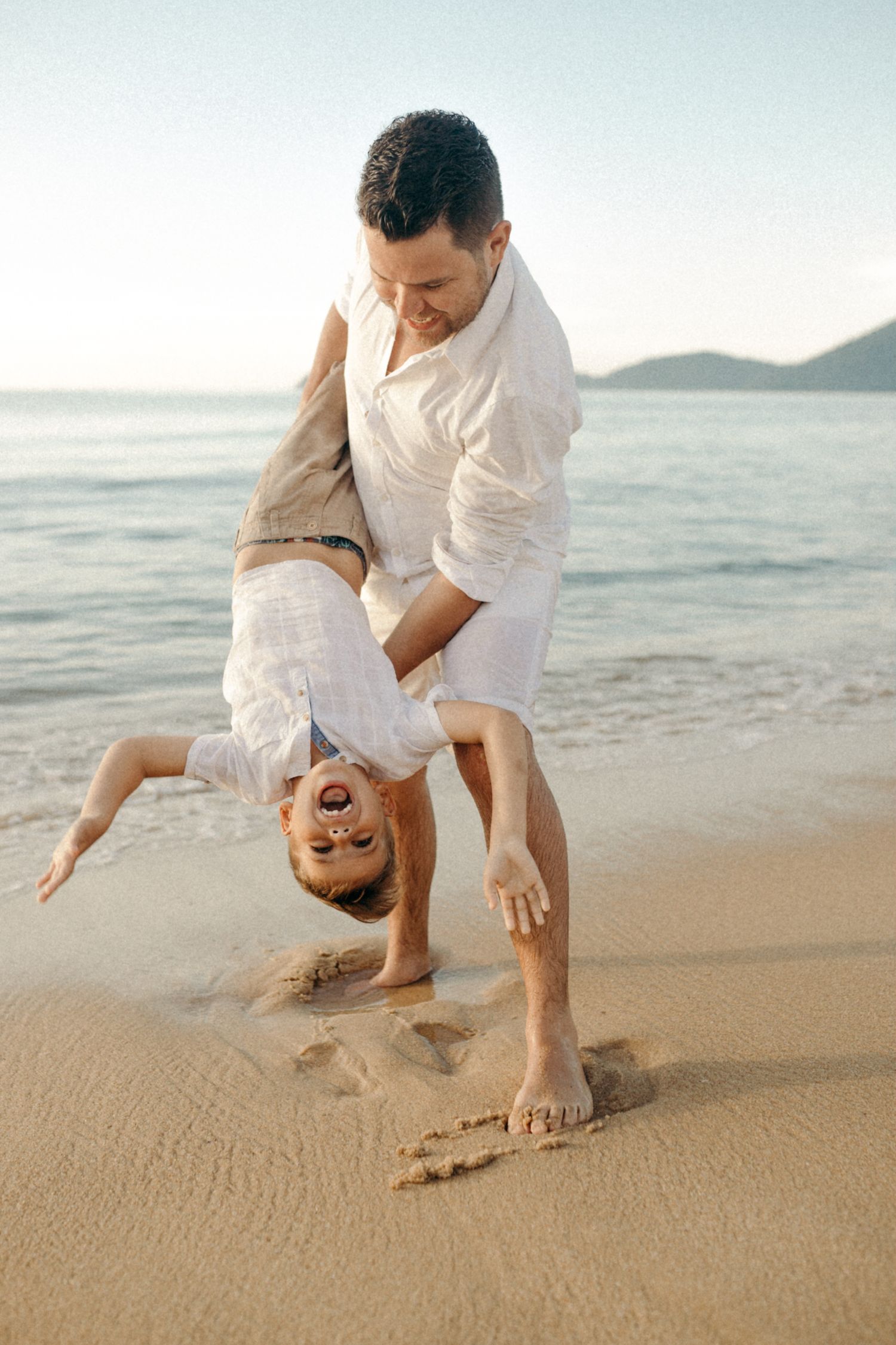 Playful beach scene showing fun activity near the ocean waves.