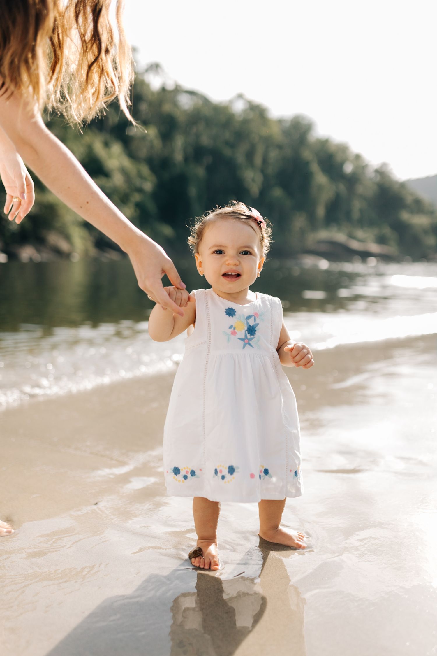 A delightful beach scene with family members in matching white outfits.