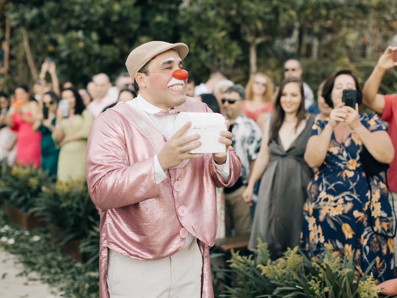 Guest in pink outfit enjoying outdoor wedding celebration.