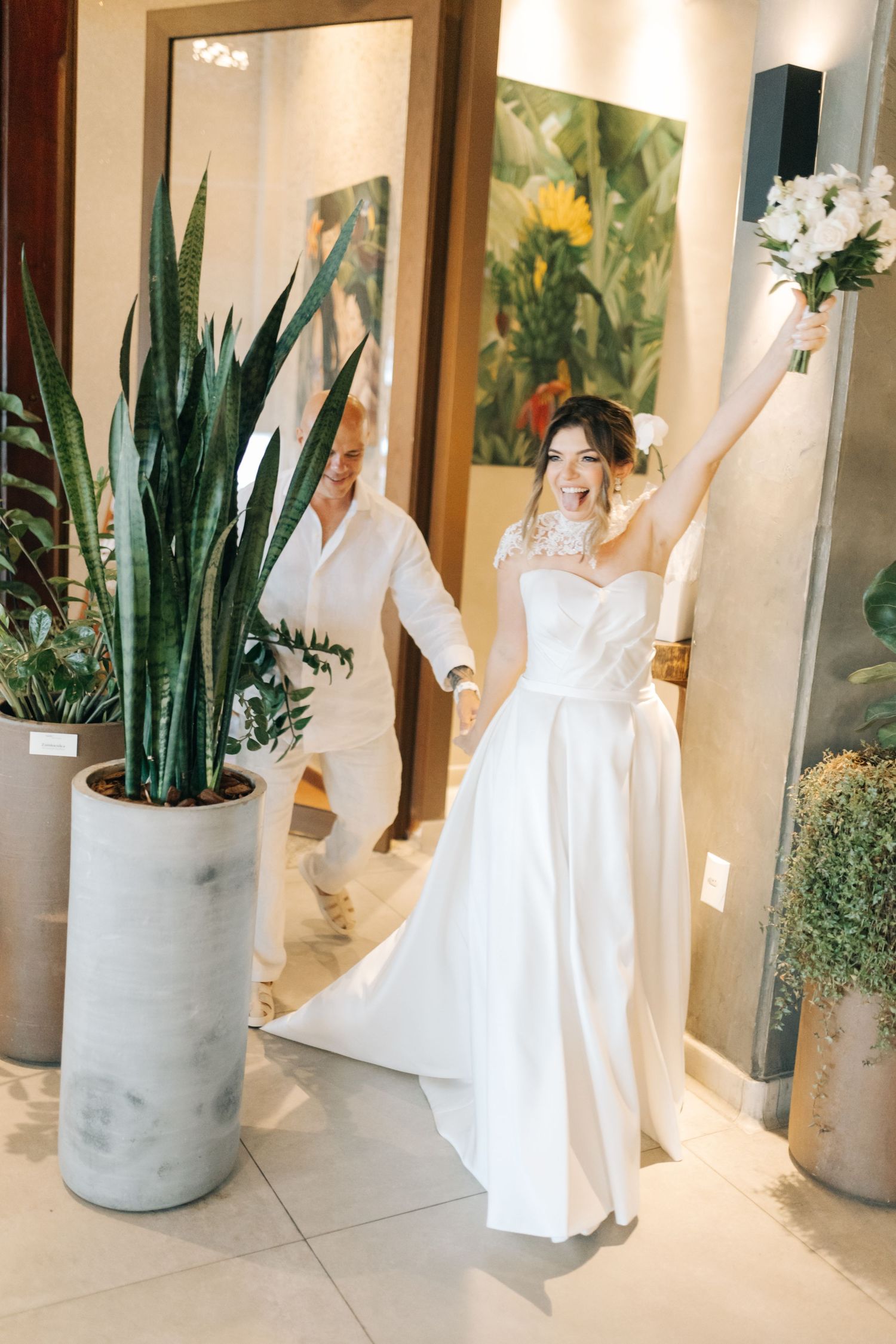 A joyful sequence showing dance movements in a white dress against a hallway with potted plants.