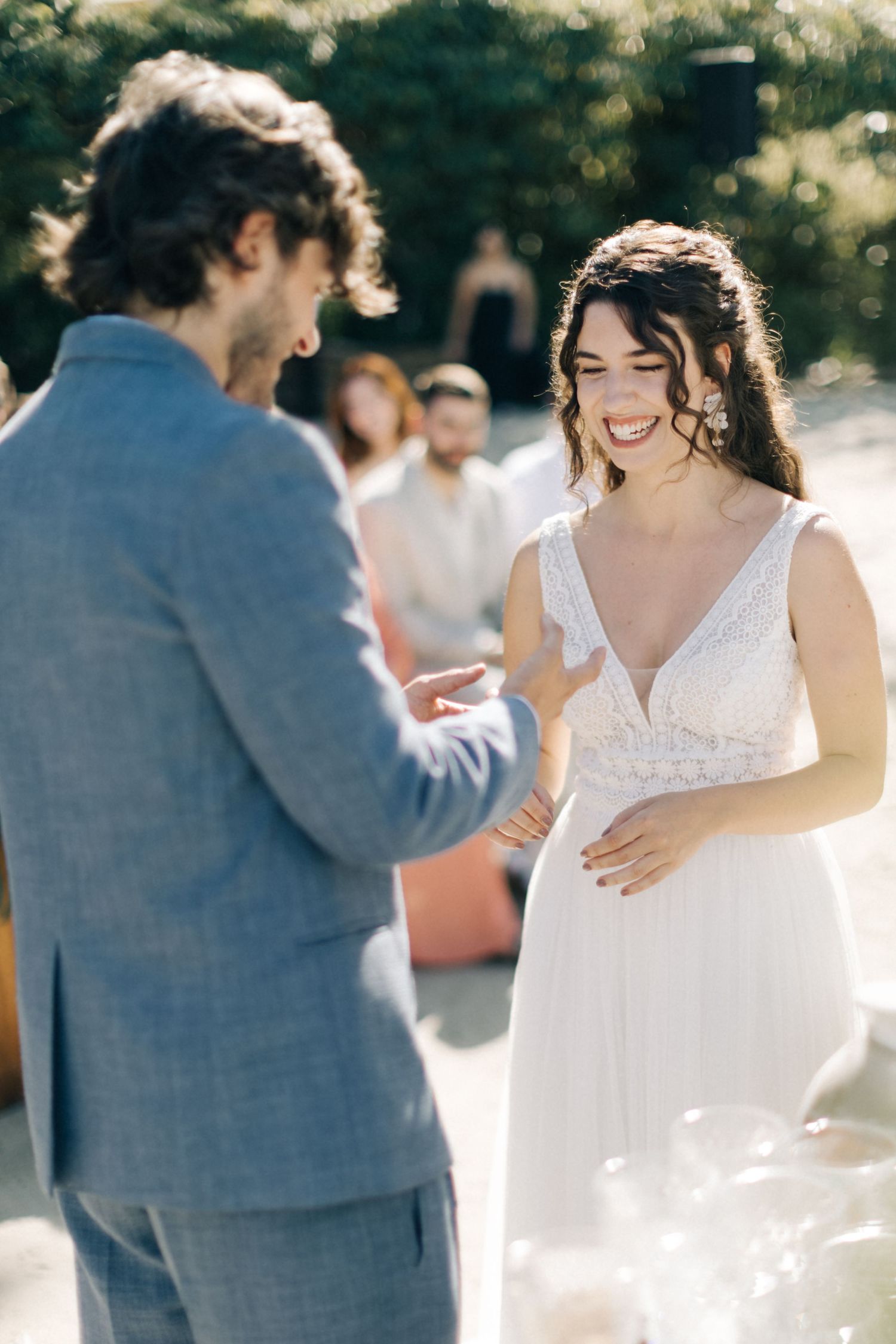 Intimate moment between newlyweds during beach wedding ceremony with soft lighting.