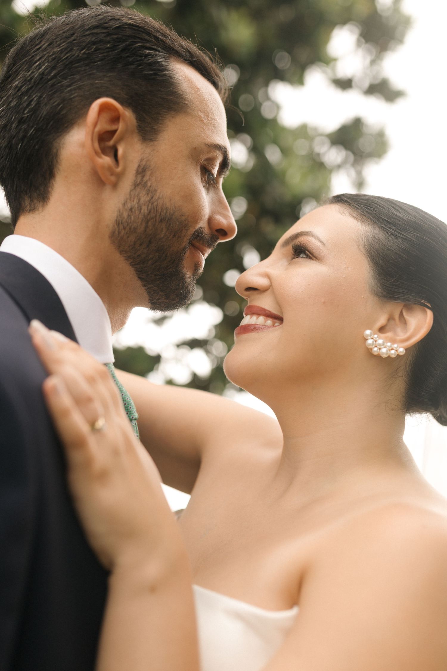 Romantic wedding moment captured in soft natural lighting outdoors.