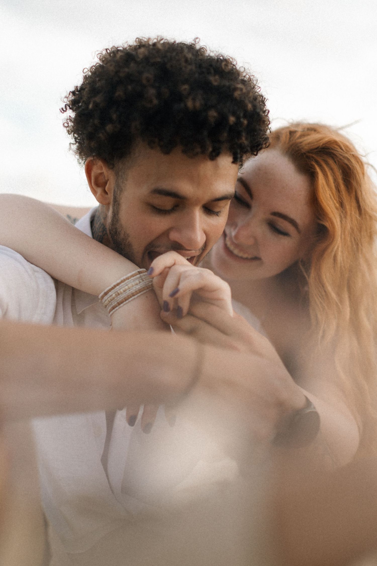 An intimate couple's photoshoot with soft focus and dreamy lighting.