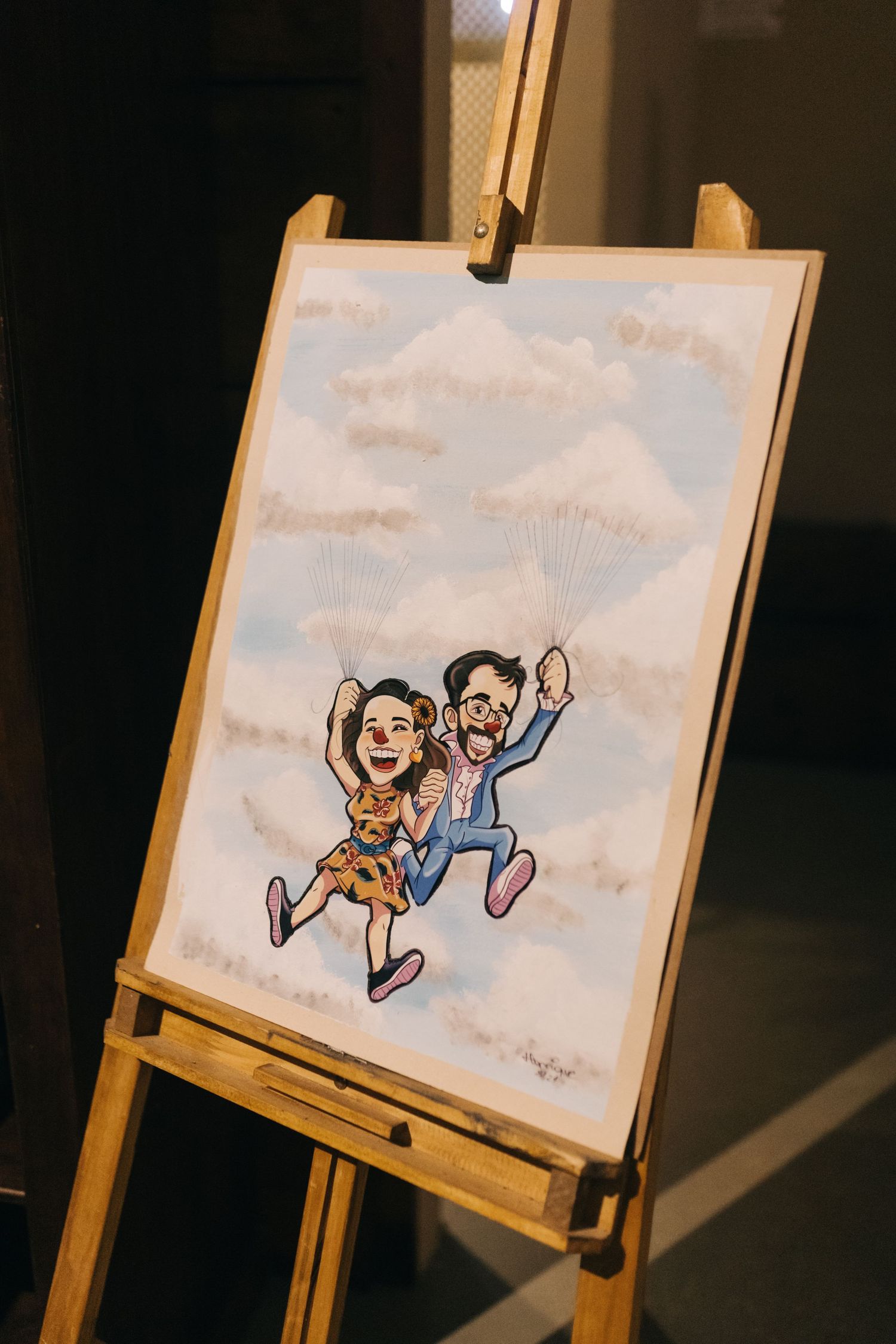 An artistic illustration of a couple jumping displayed on an easel.