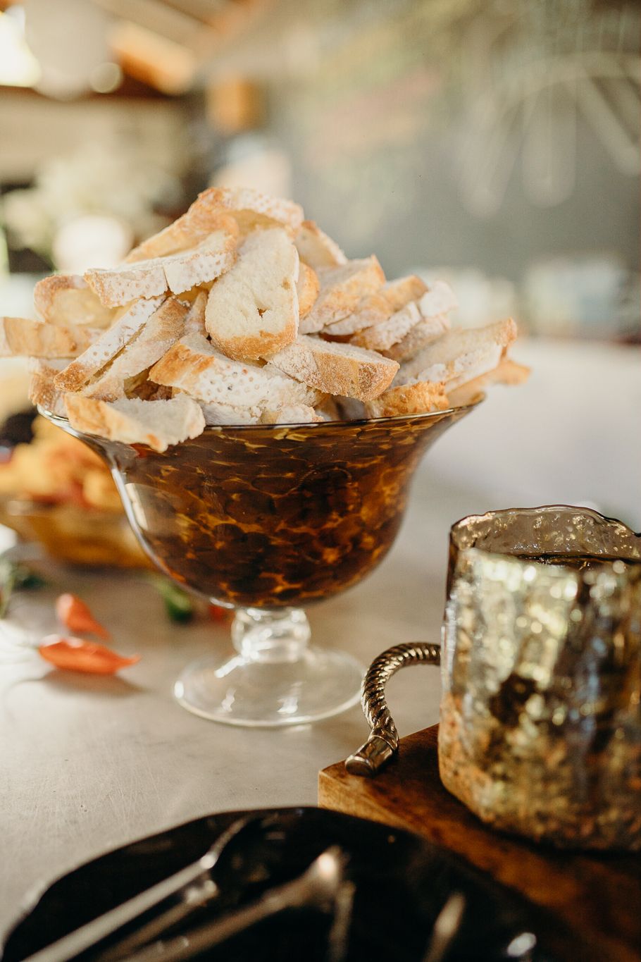 Rustic appetizer spread featuring cheese boards and charcuterie with crispy breadsticks on elegant glass stands.