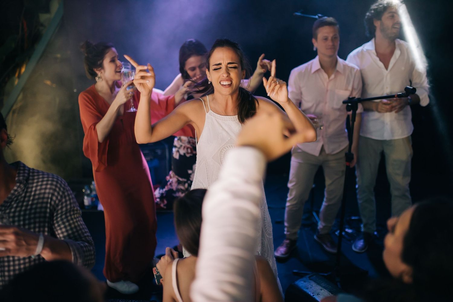 Reception celebration with dancing and party lights on dance floor.