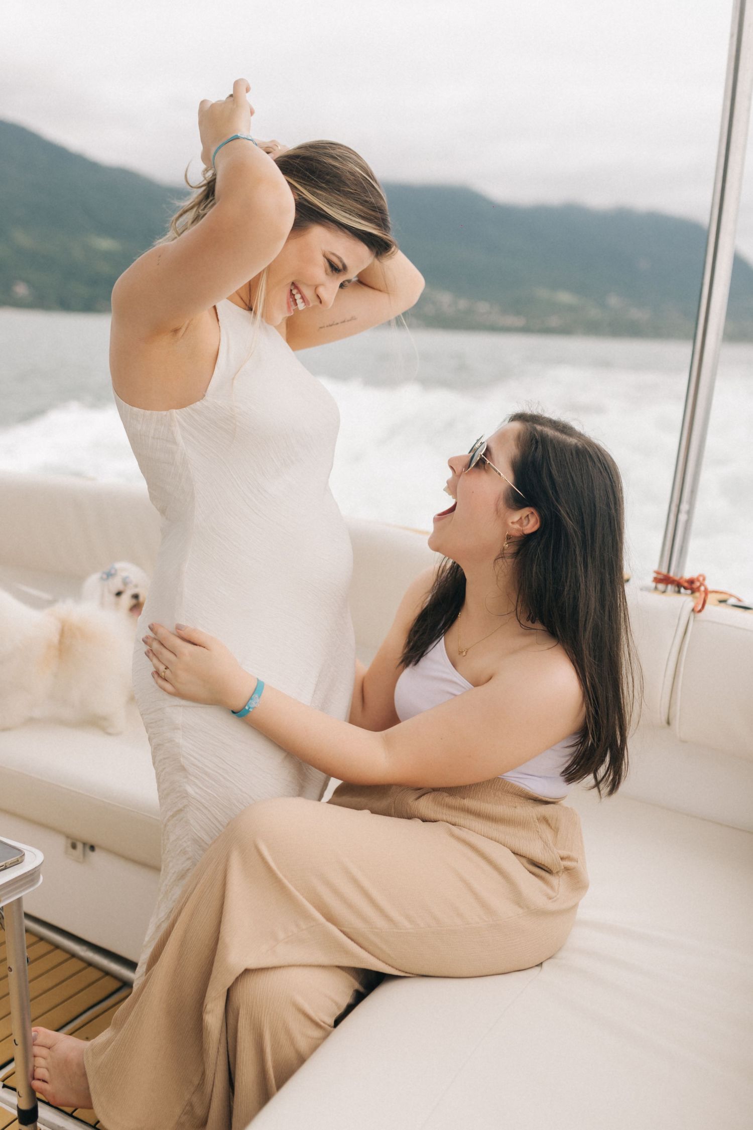 Friends enjoying candid laughter together on luxury yacht deck.
