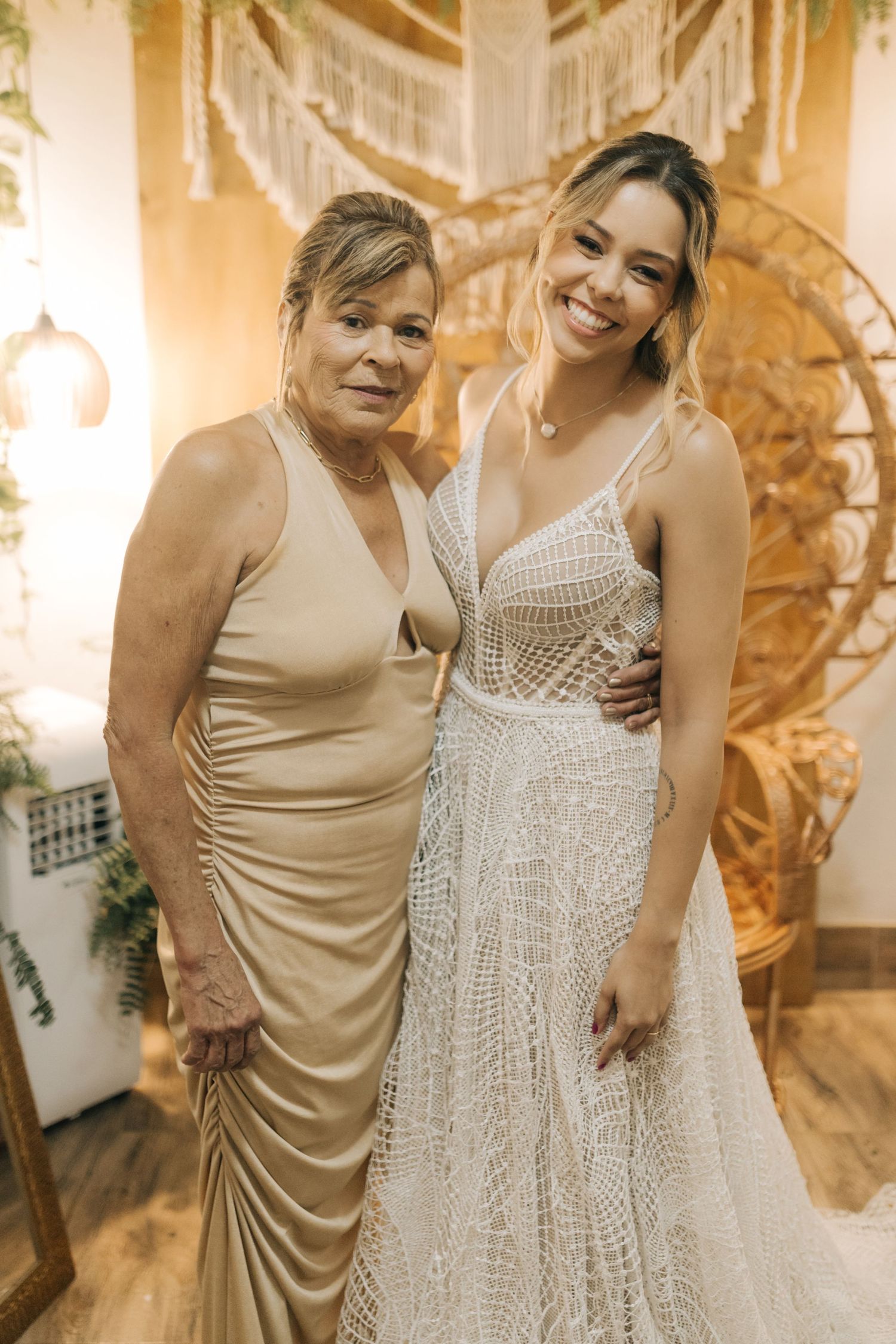 Heartwarming wedding moment shared between two guests in neutral and white dresses.