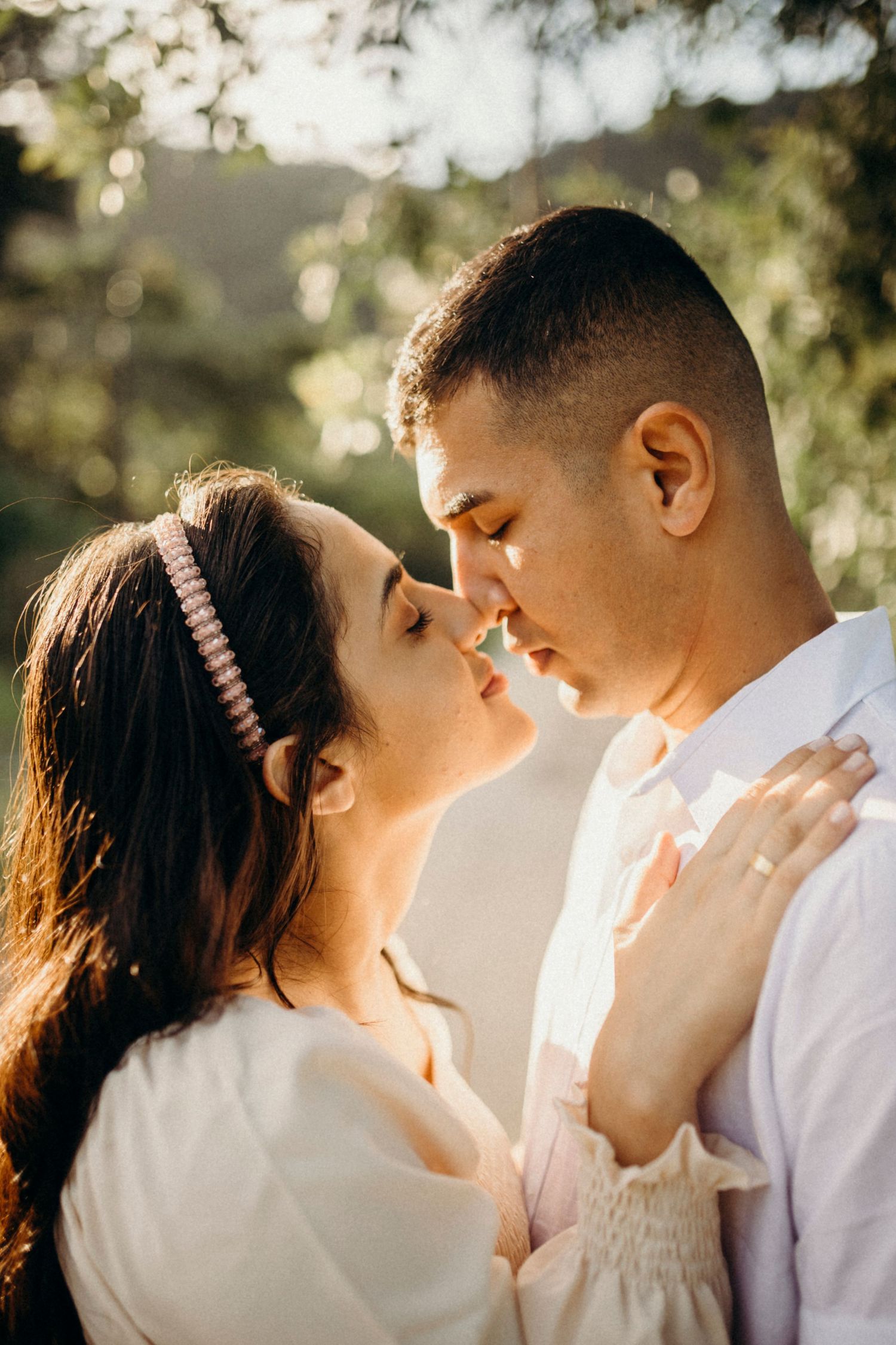 Close-up shots of a couple sharing intimate moments in warm sunlight.
