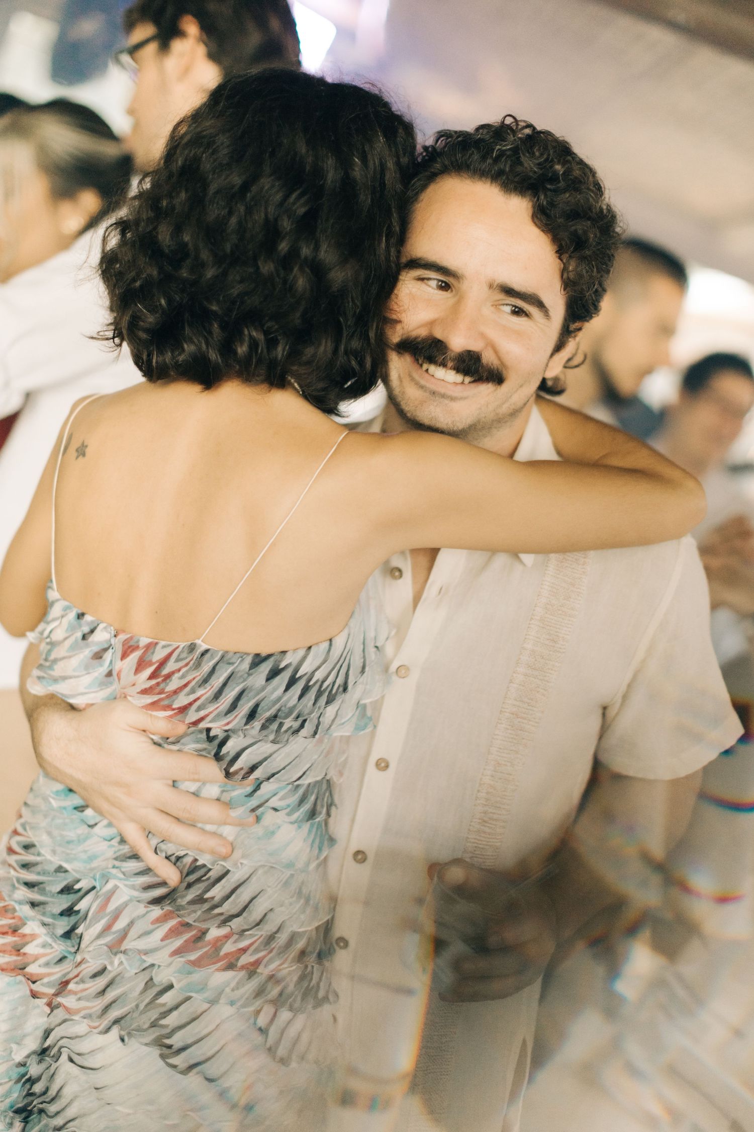 Dancing pair embracing during a romantic moment on the dance floor.