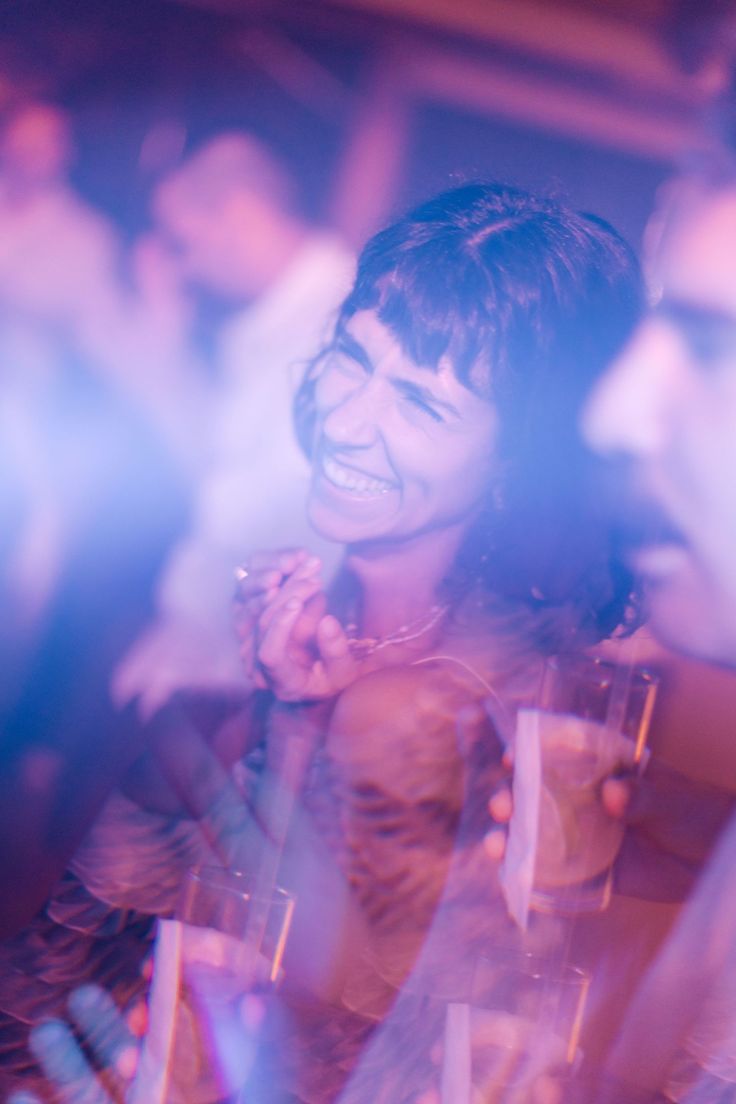 Guest enjoying the party atmosphere with purple lighting effects.