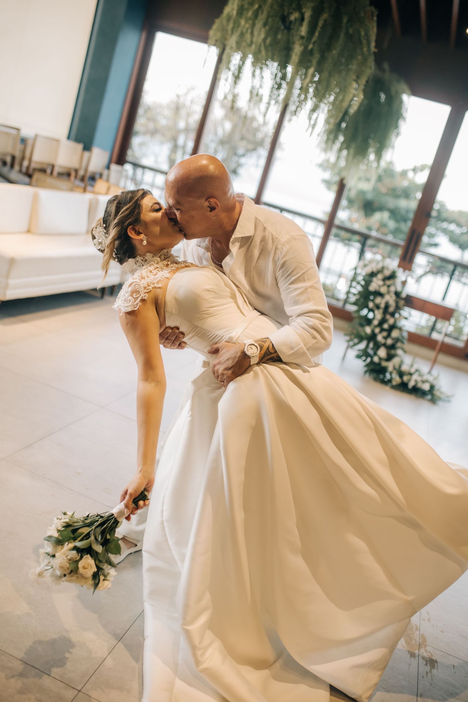 Romantic wedding dance sequence with dramatic dip poses in an elegant venue.
