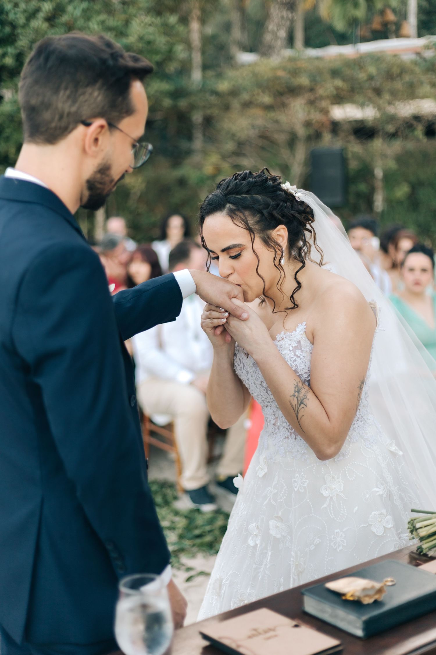 Emotional moments during wedding ceremony on beach with couple and officiant.