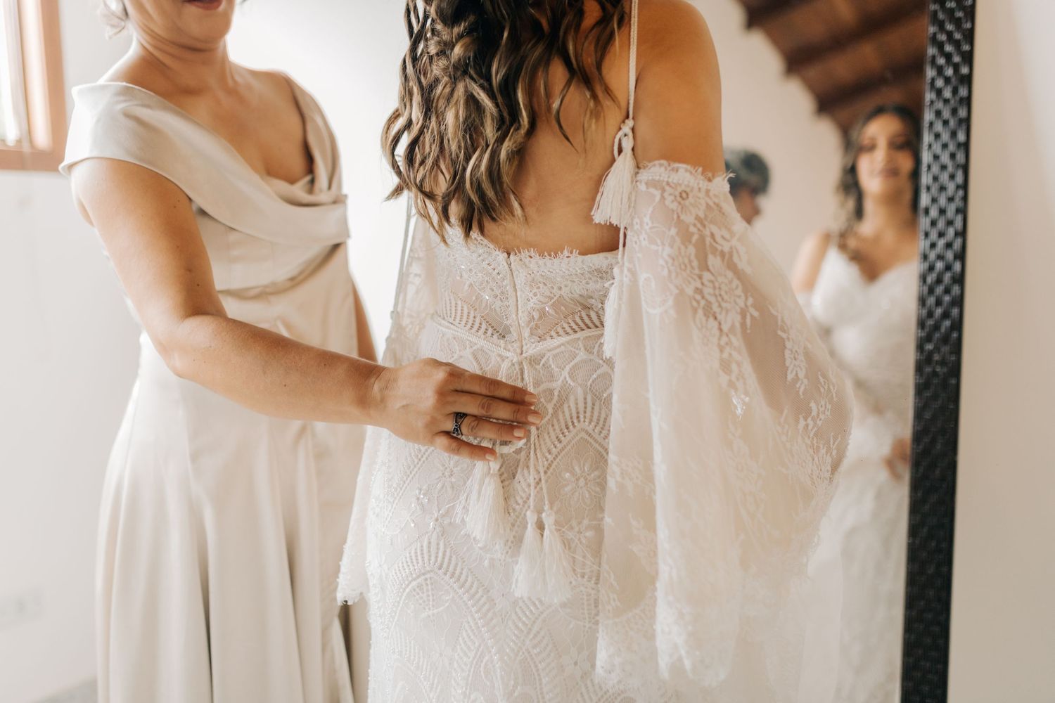 Close up of wedding dress details being adjusted.