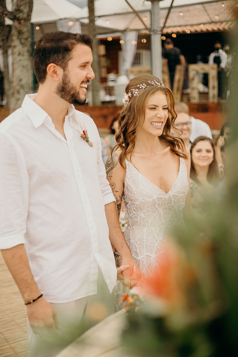 Happy couple sharing a joyful moment during their beachside wedding celebration.