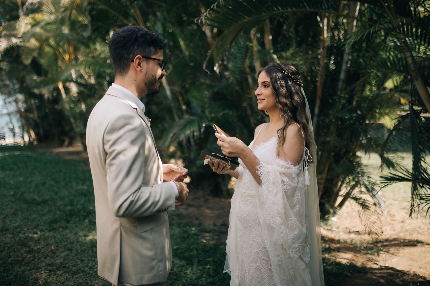 Bride and groom sharing heartfelt messages during their garden ceremony.