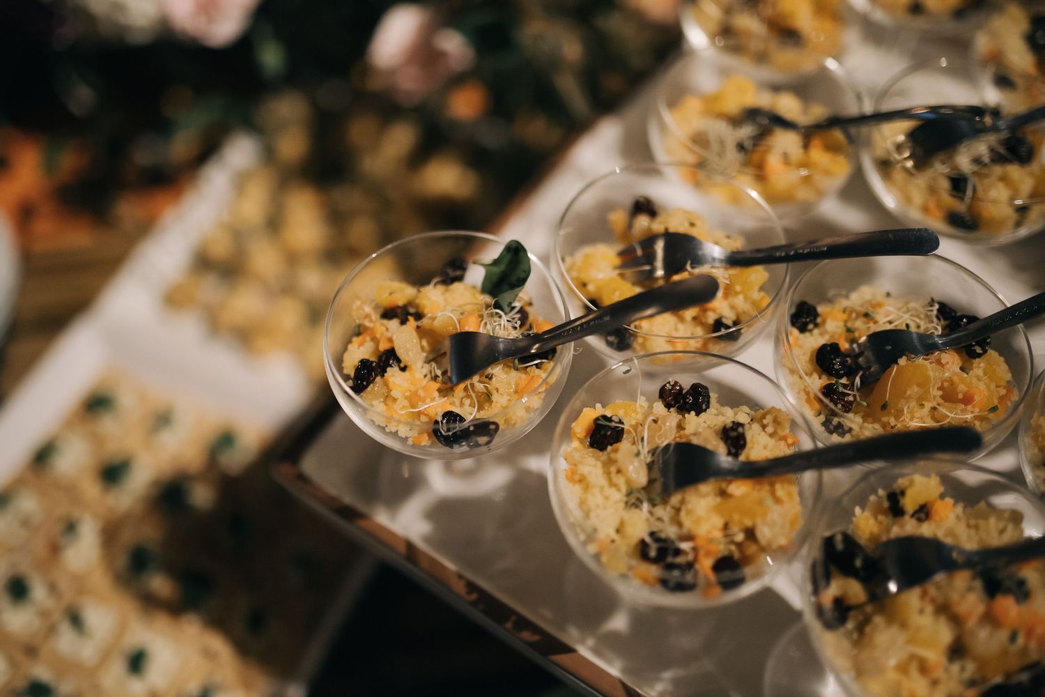 Close-up of appetizers served in individual glass containers at an elegant event.