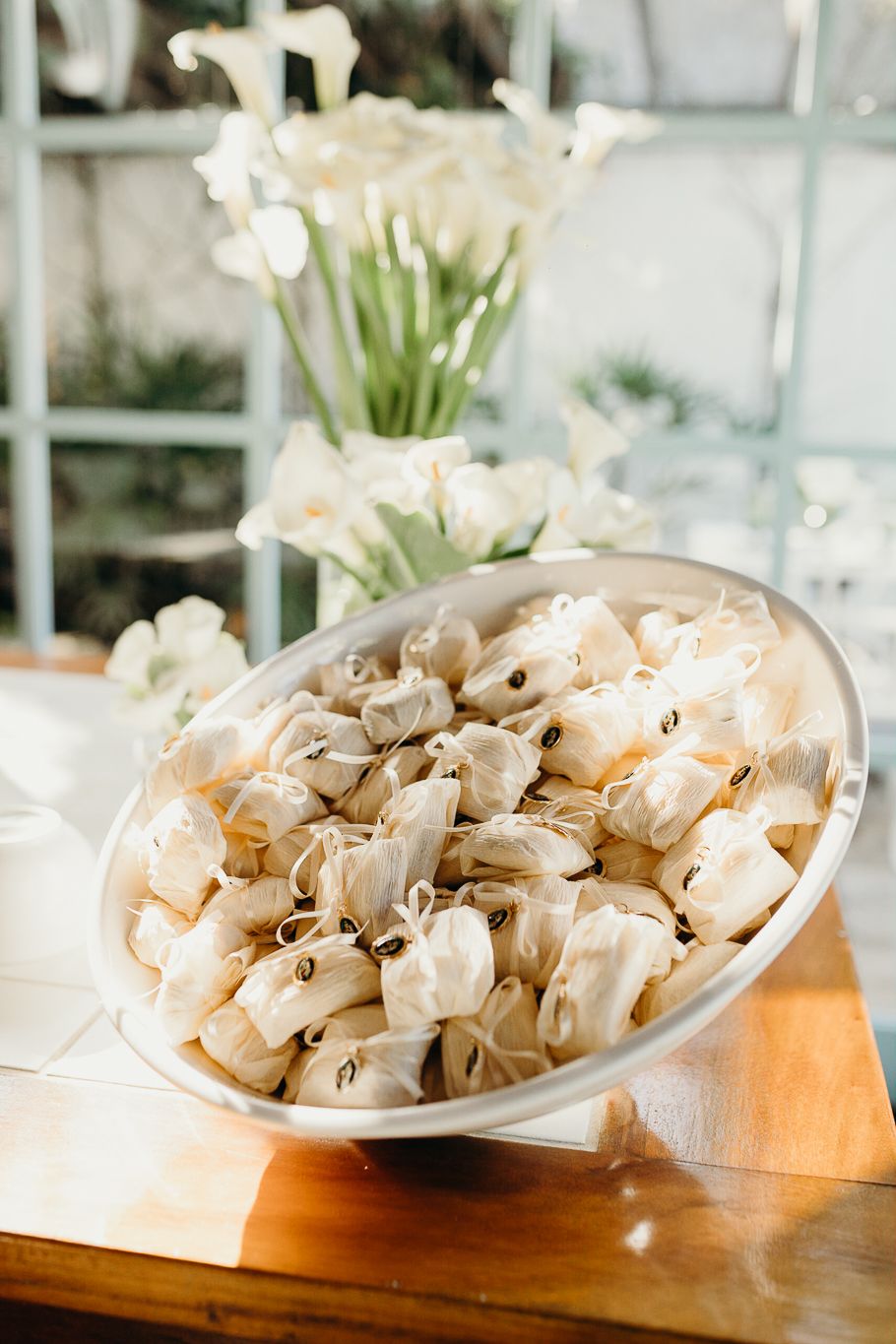 White paper cones arranged on wooden serving platters for an elegant event display.