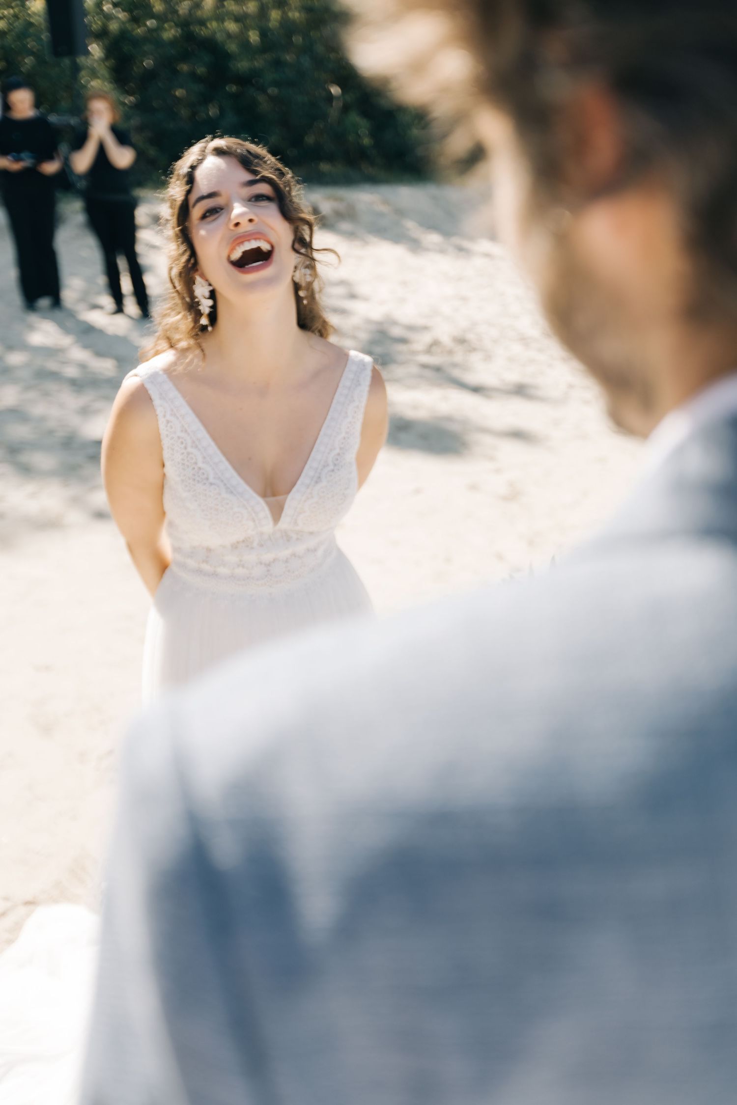 A joyful moment captured during a beachside wedding ceremony.