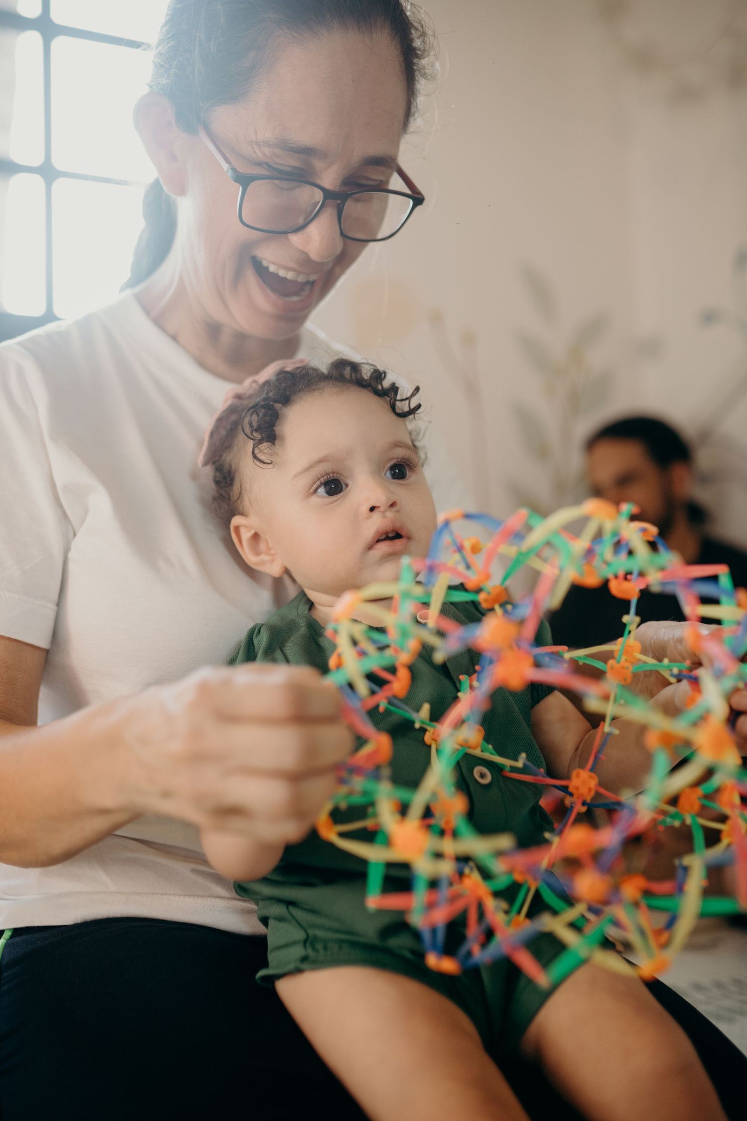 A joyful indoor playtime moment with colorful construction toys.