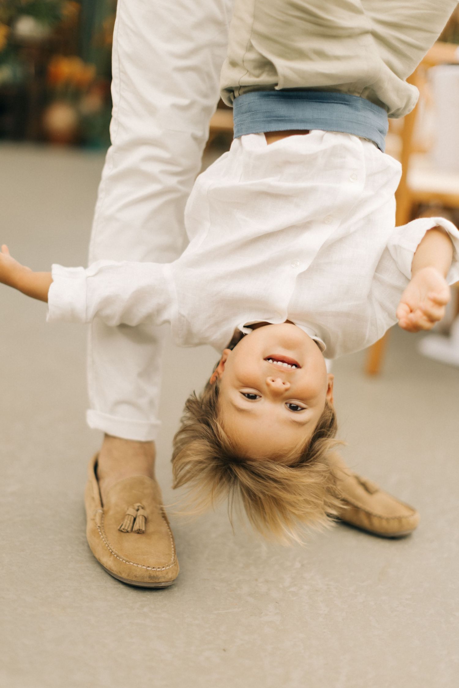 A playful upside-down perspective shot against a grey floor.