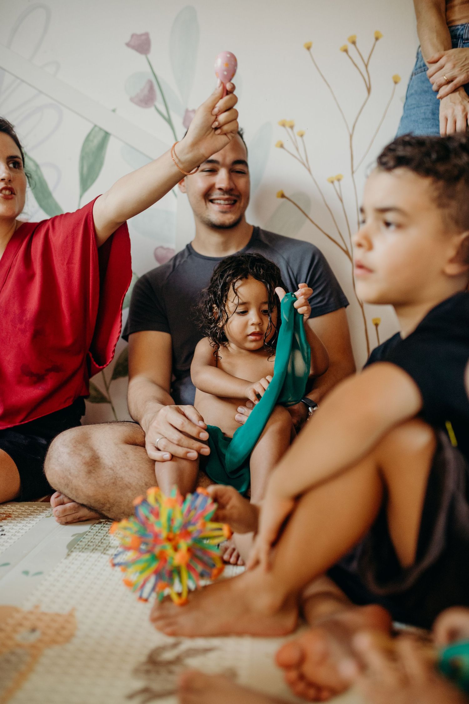 Festive gathering with colorful decorations and play elements in an indoor setting.