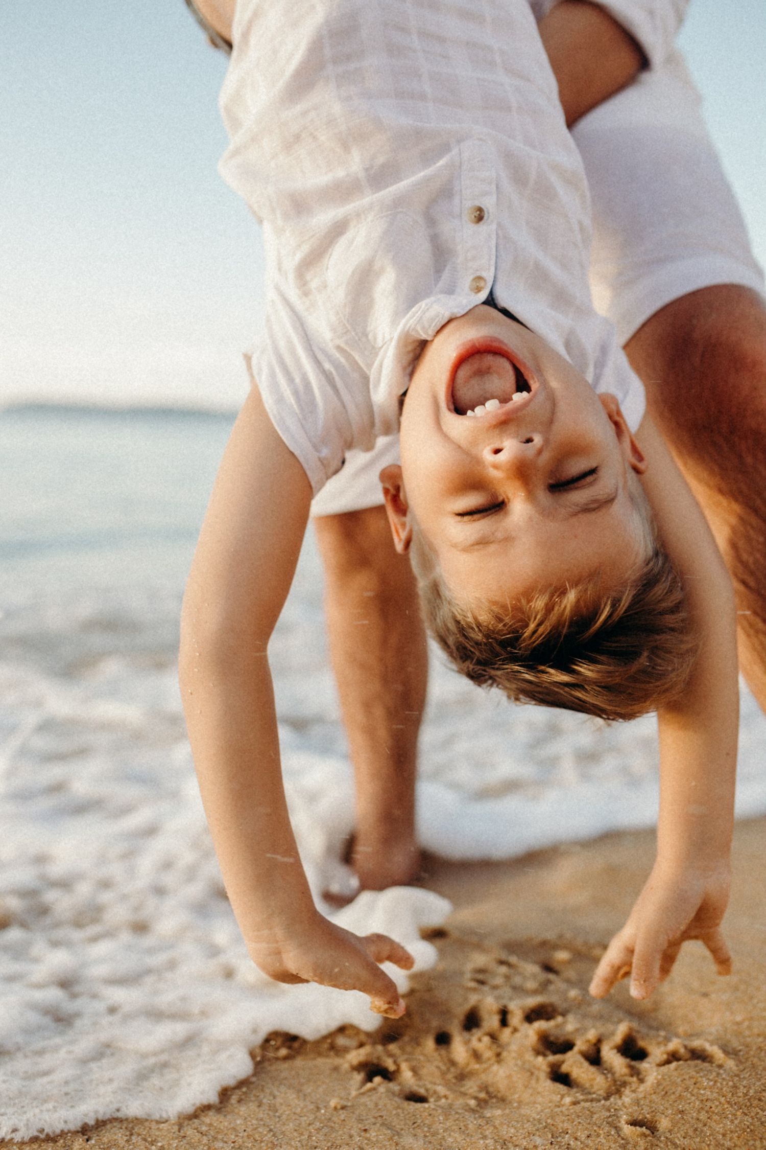 Sequence showing upside-down fun moments at the beach.