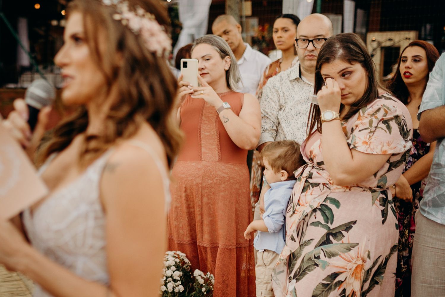 Outdoor wedding reception with warm lighting and rustic decor elements.