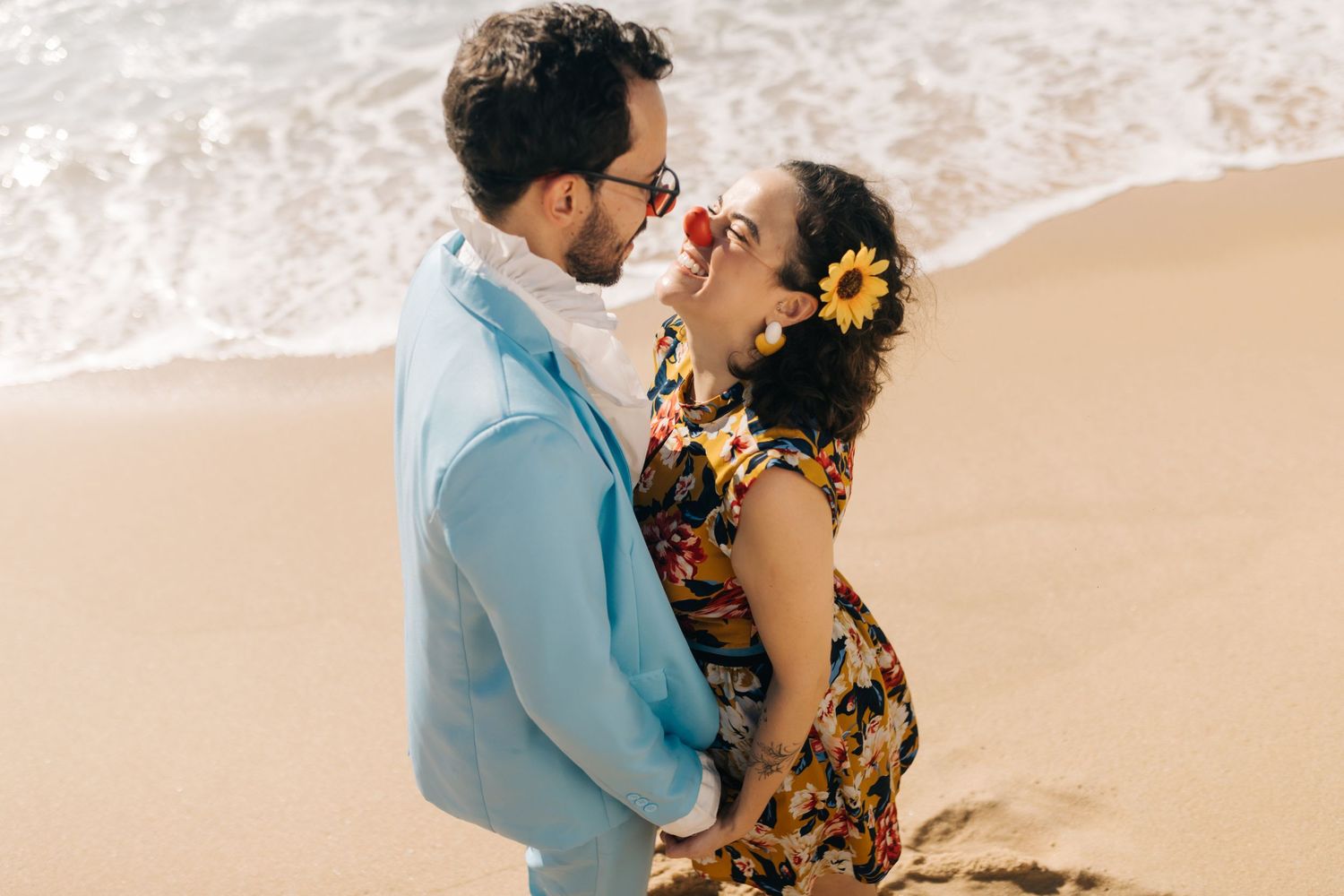 A couple sharing a playful moment together at a tropical beach setting.