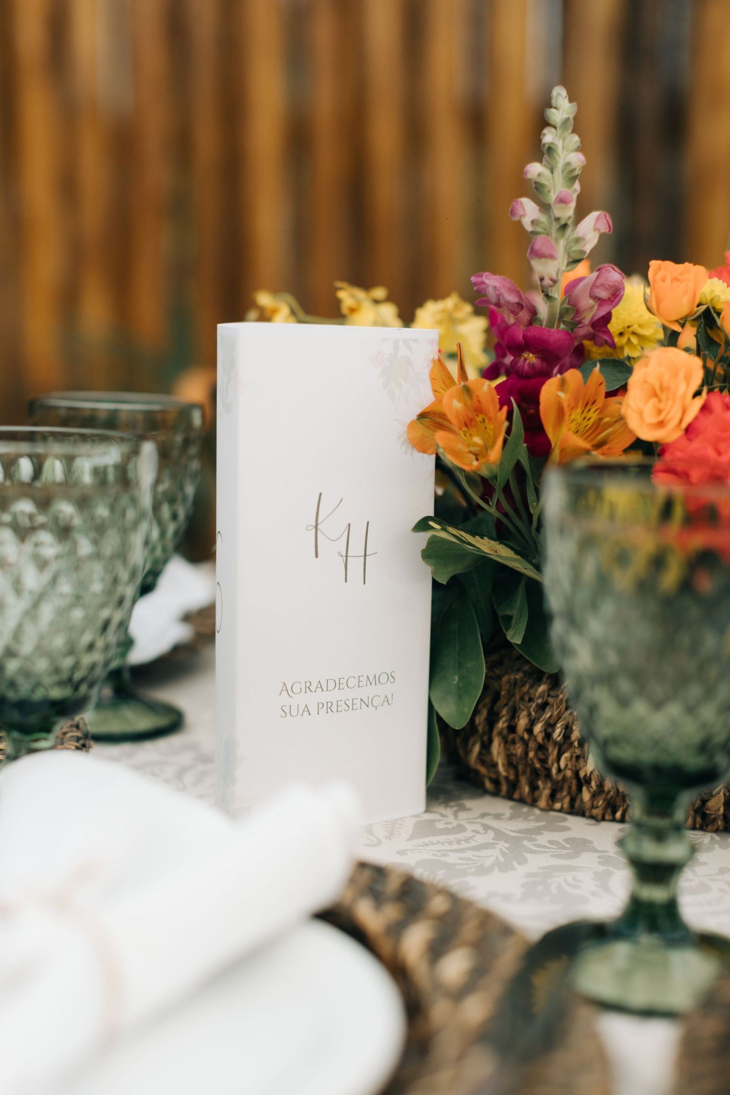 Wedding table decorations featuring place cards with colorful floral arrangements.