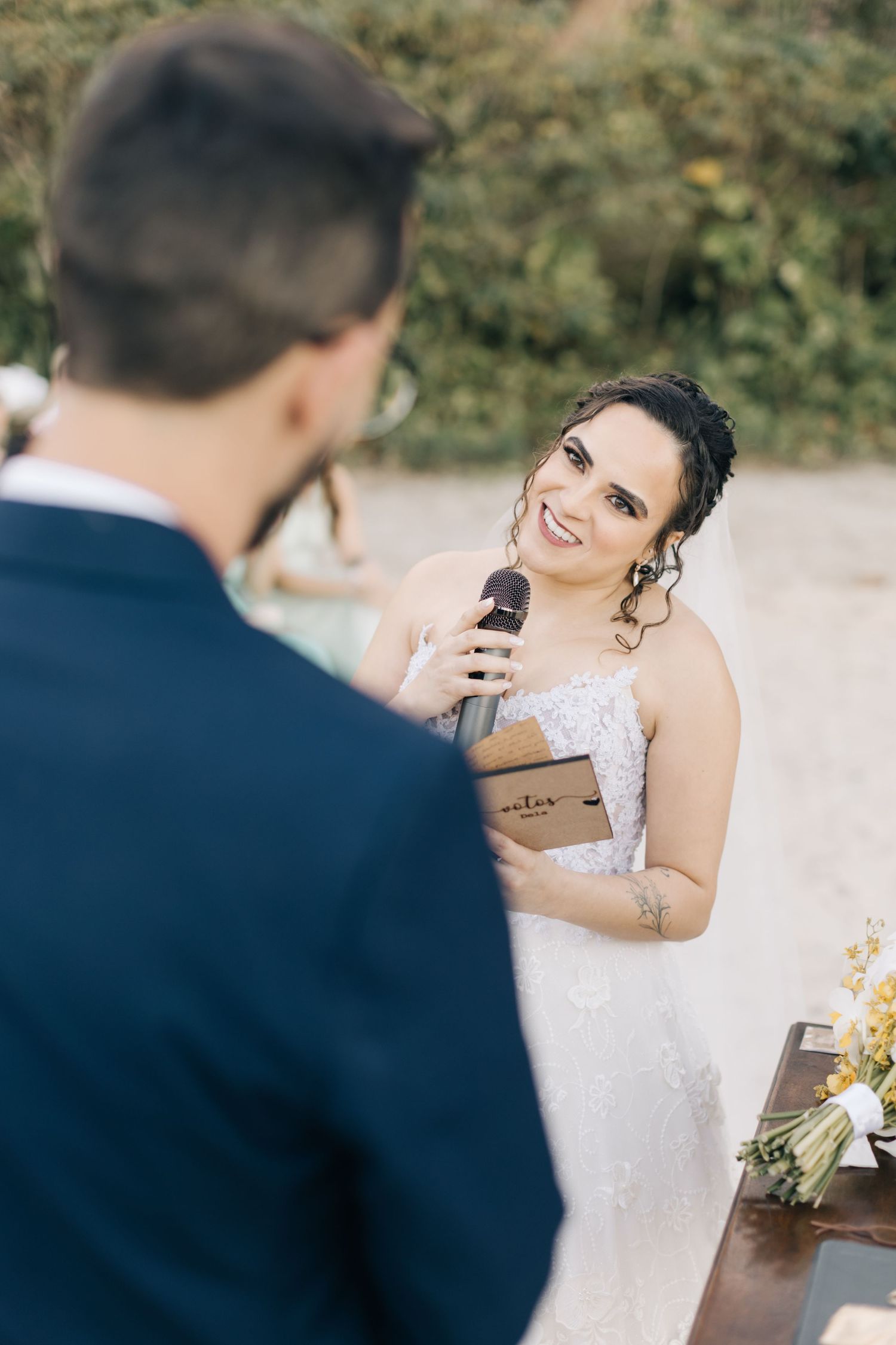 Emotional exchange of vows during intimate beach wedding ceremony.