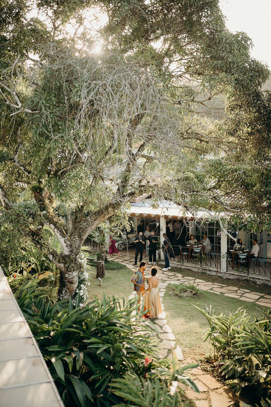 Garden path through tropical landscaping leading to covered outdoor venue.