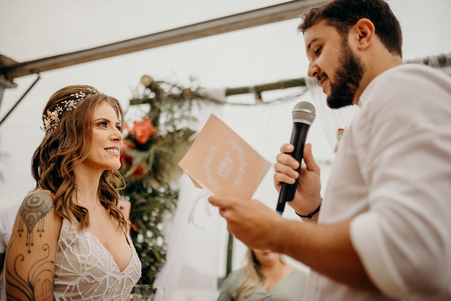 Couple sharing personal vows during emotional outdoor wedding ceremony.